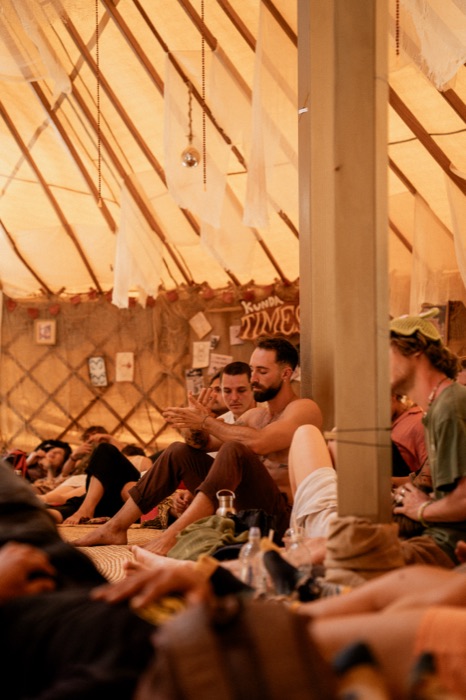 Communal gathering beneath the Kunda Times wall during a sound bath