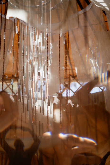 Detail of hanging mirror shards and crystal beads catching the light
