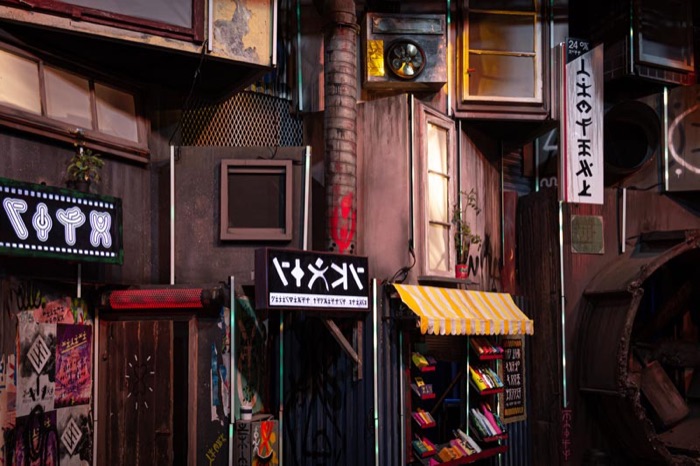 Painted alley facade with neon signage and awning