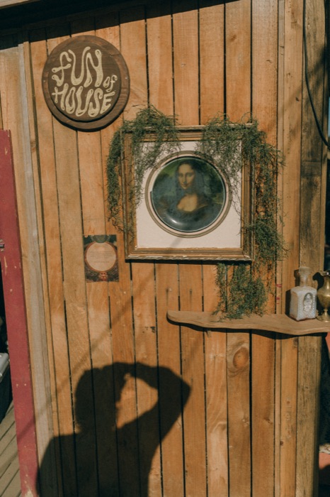 Fun of House shrine wall with framed portrait and moss